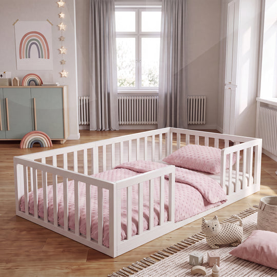 Lit bas Montessori laqué blanc dans une chambre d'enfant avec affiche arc-en-ciel, guirlande lumineuse en forme d'étoiles et linge de lit rose. Entièrement généré par IA