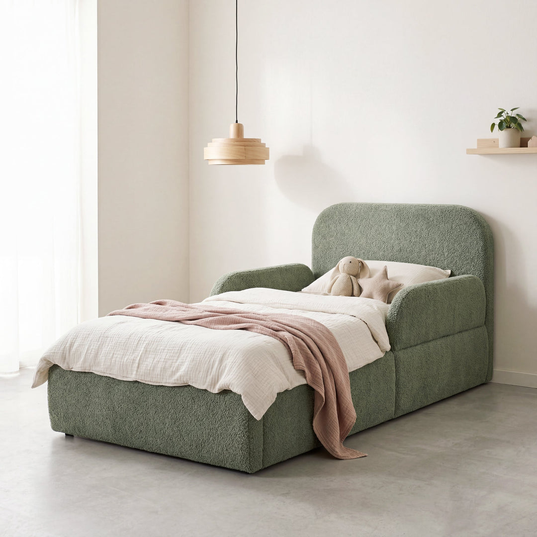 Green bouclé children's bed with fall protection, wooden pendant lamp and plant in the room. Fully AI-generated.