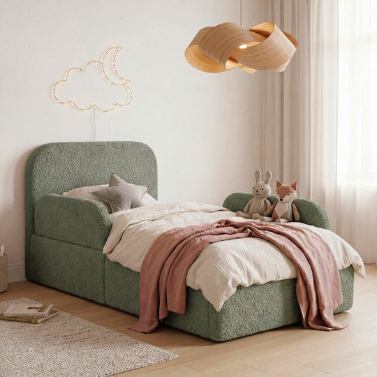 Green bouclé children's bed with fall protection, cuddly toys and moon-and-cloud fairy lights. Fully AI-generated.