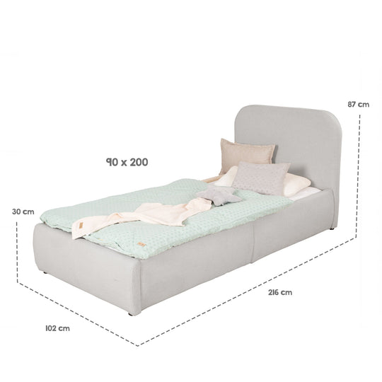 Gráfico de medidas de la cama infantil gris claro: superficie de descanso 90×200 cm, medidas totales 216×102×87 cm, arcón 30 cm.