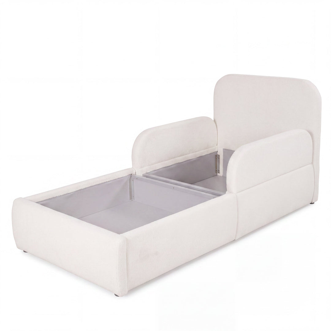 Cama infantil blanca de bouclé abierta con el arcón de almacenaje visible, imagen recortada.